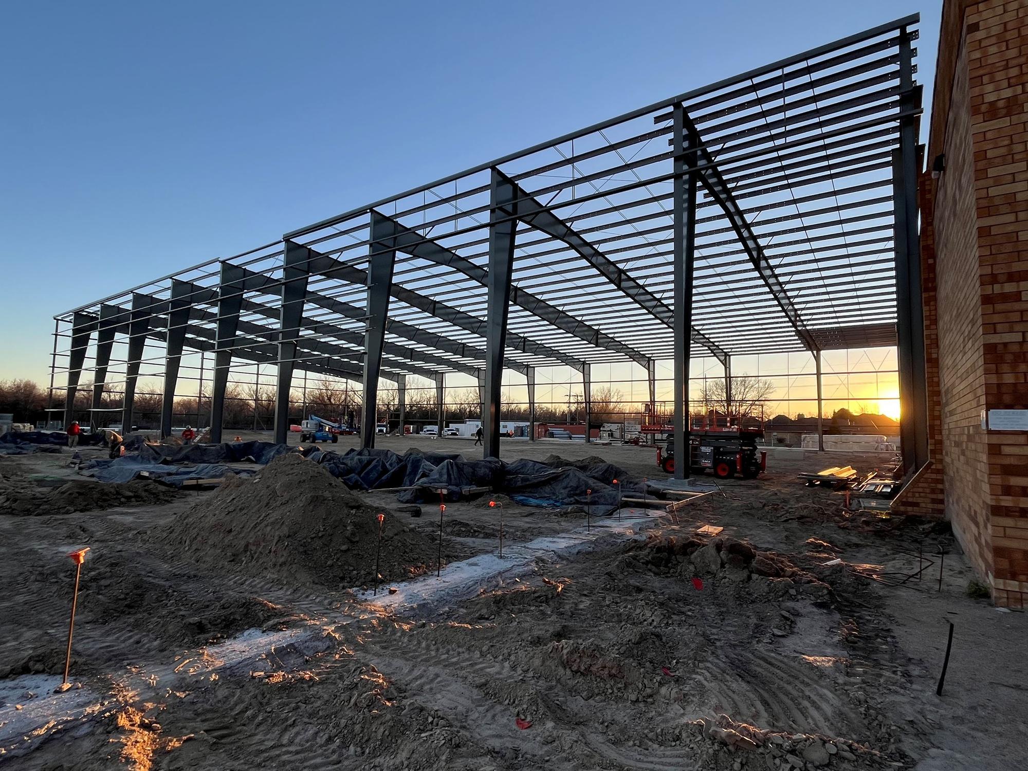 A public safety facility under construction at dusk